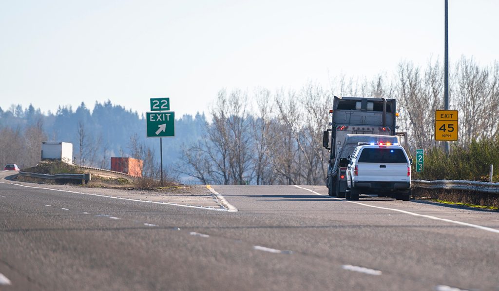 Photo of big rig semi truck pulled over by state police.