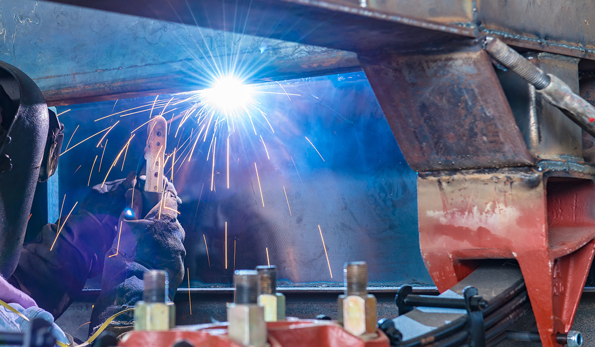 Photo of technician welding on truck